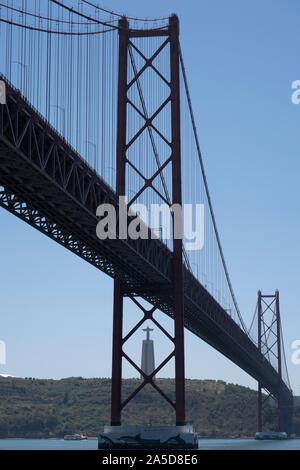 Ponte 25 de Abril suspension bridge over the Tagus river and the Sanctuary of Christ the King Cristo Rei statue overlooking Lisbon, Portugal