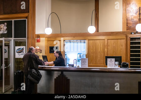 Guest checking in at the reception of Lafayette Hotel in Buffalo, NY Stock Photo