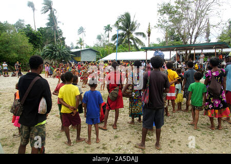 Locals and Visitors watching a Cultural Performance organised on the Occasion of a Cruise Ship Visit to Kiriwina Islan Stock Photo