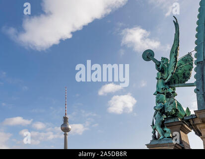 The angel of the dome of the Cathedral of Berlin, Germany and the Television Tower against a beautiful blue sky with some clouds Stock Photo