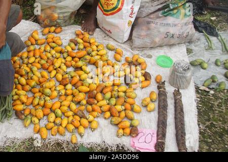 Pile of ripe orange Betel Nuts at a makeshift Market Stall in Papua New Guinea Stock Photo