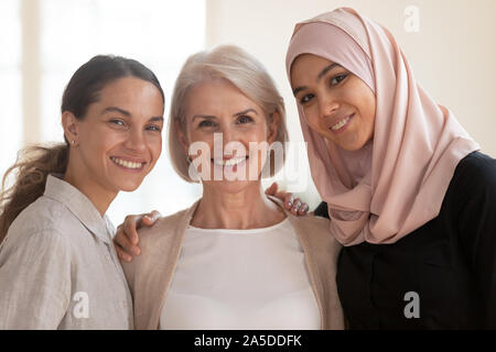 Happy beautiful diverse two generation women bonding looking at camera Stock Photo