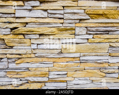 Part of stone masonry with rectangular stones, rough old wall background Stock Photo