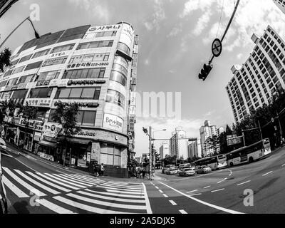 Seoul, South Korea - June 2, 2017: Pedestrians stopping at pedestrian crossing and waiting green sign of traffic light in the central street in Seoul. Stock Photo