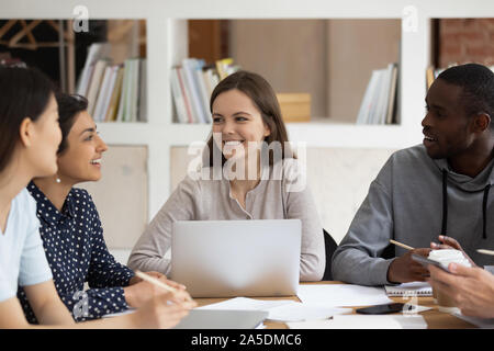 Multi-ethnic students sitting at classroom desk study together Stock Photo