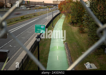 Albany, New York - Oct 15, 2019: Highway View and Bycle Trail of Interstate 787 thru Wired Fence Stock Photo