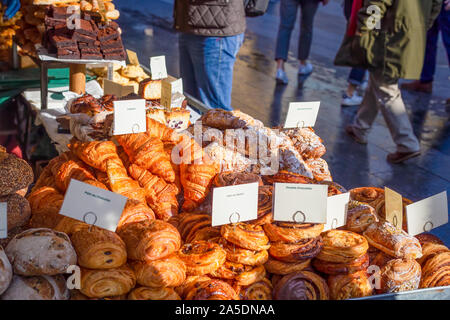 Variety of artisan pastries and breads on display for sale at a street market stall in the UK Stock Photo