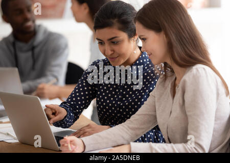 Diverse students take part in shared task solving using pc Stock Photo