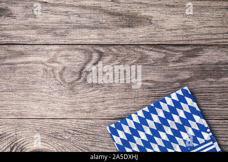 Folded bavarian napkin on a wooden table with copy space, top view. Food background Stock Photo
