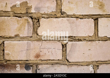 Old brick wall closeup. Abstract background from dilapidated bricks. Stock Photo