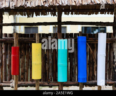 colorful bamboo container display on a wood wall Stock Photo