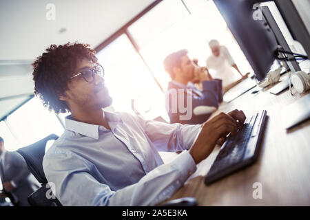 Programmer working in a software developing company office Stock Photo