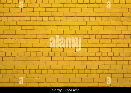 Yellow or gold painted brick wall. Stock Photo