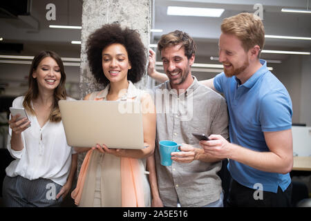 Programmers cooperating at IT company developing apps Stock Photo