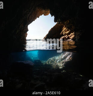 Inside a sea cave on the shore, split view over and under water, Mediterranean, Spain, Costa Brava, Catalonia, Palamos Stock Photo