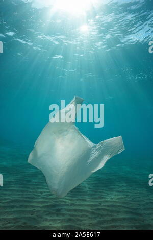 Plastic bag pollution underwater with sunlight in the sea, Mediterranean, natural scene, France Stock Photo