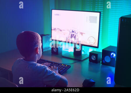 Boy is playing on the computer. Gaming industry growth concept and the problem with the mental development of children who spend a lot of time at the Stock Photo