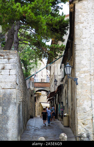 San Marino medieval street, old vintage lantern on the walls. Medieval walls from bricks and stones. Stock Photo