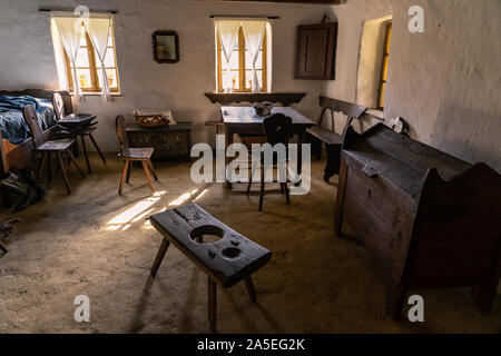 old hungarian village museum tiller house with light from the window Stock Photo