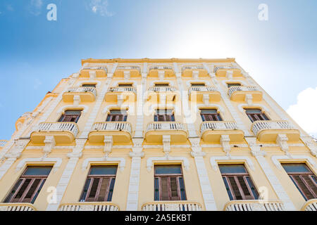 Facade of a yellow colonial building in Havana, Cuba. Stock Photo