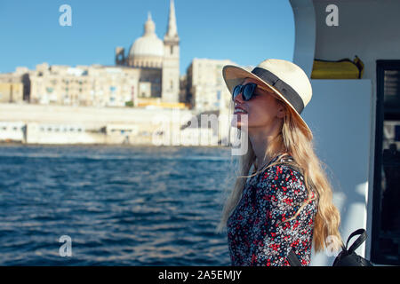 Excited young Mediterranean blonde woman arriving to Valletta, Malta Stock Photo