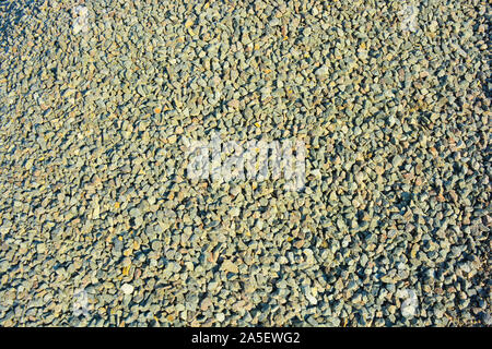 Building materials for construction and repair work, clean fine gravel rubble, a pile of building pebbles in the autumn sunlight. Stock Photo