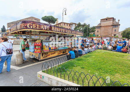 Bunch of young tourists visiting Vatican City around a beverage and ice cream kiosk during spring, Rome, Italy, EU. Stock Photo