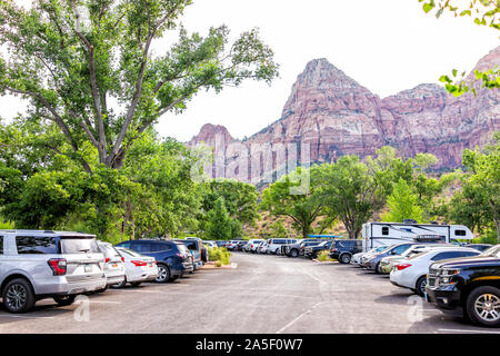 Springdale, USA - August 6, 2019: Zion National Park cliffs in morning at parking lot near visitor center in summer with many cars Stock Photo