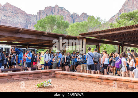 Springdale, USA - August 6, 2019: Zion National Park in Utah at shuttle bus stop visitor center in summer with crowd of many people waiting in line qu Stock Photo