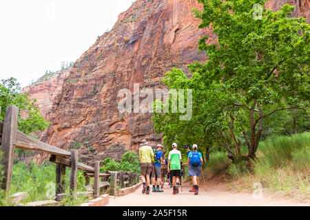 Springdale, USA - August 6, 2019: Zion National Park Riverside Narrows walk trail road in Utah with people walking hiking on popular path by red canyo Stock Photo