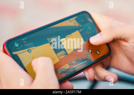 Bishkek, Kyrgyzstan - October 10, 2019: Man playing online game in call of duty mobile on iphone 11 Stock Photo