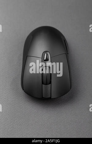 black wireless computer mouse on a black background. modern office equipment Stock Photo