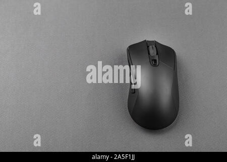 black wireless computer mouse on a black background. modern office equipment Stock Photo