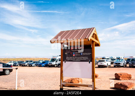 Page, USA - August 10, 2019: Sign entrance to Navajo tribal Adventurous tours at Upper Antelope slot canyon in Arizona and parking lot with cars Stock Photo