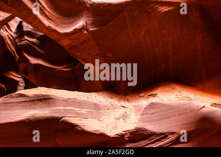 Abstract closeup view of sand on rocks with shadows and light at upper Antelope slot canyon sandstone in Page, Arizona Stock Photo