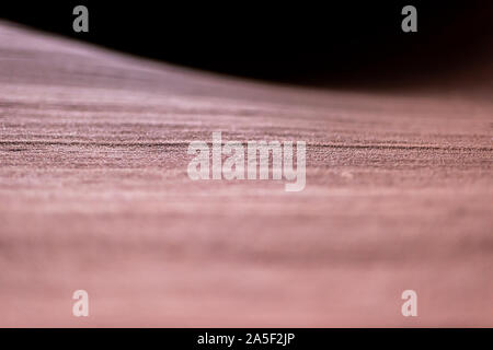 Abstract closeup view of patterns and texture on surface of red rock sandstone at upper Antelope slot canyon in Page, Arizona Stock Photo