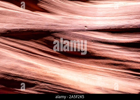 Abstract closeup view of patterns of light shadows contrast at upper Antelope slot canyon with wave shape rock sandstone in Page, Arizona Stock Photo