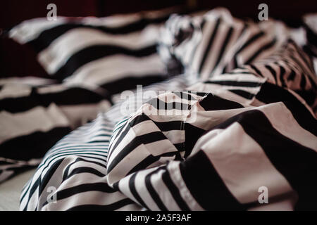 not the laid bed with a pattern of black-and-white strip, close-up. Stock Photo