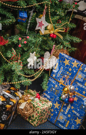 A variety of wrapped gifts under a festively decorated Christmas tree. Life style Stock Photo