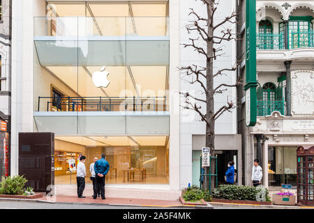 Tokyo, Japan - March 28, 2019: Shibuya district in downtown city with sign and modern architecture for Apple store during day on street Stock Photo
