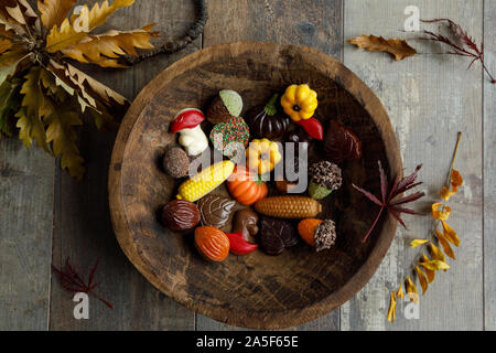 Autumn chocolate bonbon on a wooden dish Stock Photo