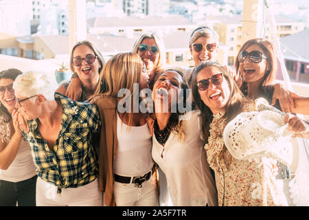 Group of female adult mixed generations people having fun together during party celebration - laughs and smile and cheerful caucasian women together h Stock Photo