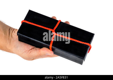 Hand holds a box with a gift. Stock Photo