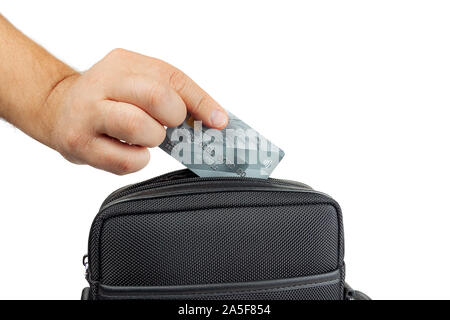 Hand pulls out of bag credit card. Stock Photo