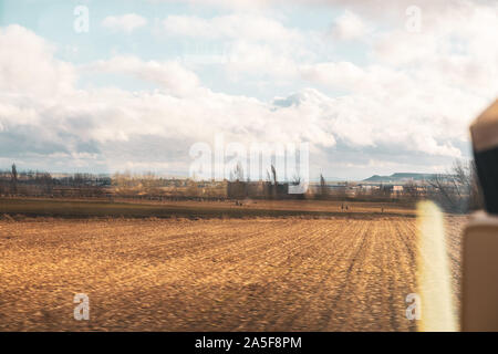 Melancholic concept of travel in autumn by train. View from the window. Stock Photo