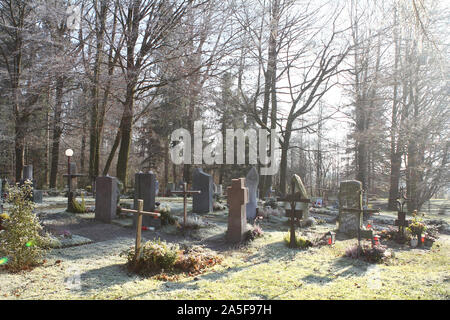 Sunrays glowing in graveyard during sunset Stock Photo