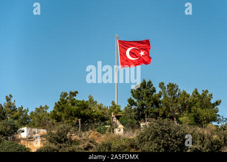 National flag of Turkey on top of the hill against the clear blue sky Stock Photo