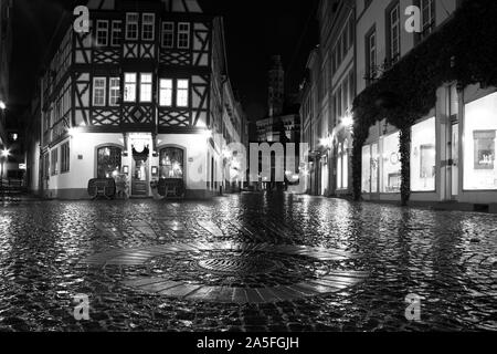 Low angle of a cobbled square, half-timbered house, Mainz at night, Germany Stock Photo