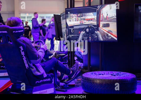 POZNAN, POLAND - October, 18th 2019: People are playing the racing simulator at the PGA2019. PGA2019 is a computer games and entertainment event organ Stock Photo