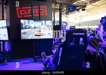 POZNAN; POLAND - October; 18th 2019:  People are playing at GRID game on PGA2019. PGA2019 is a computer games and entertainment event organized in pol Stock Photo